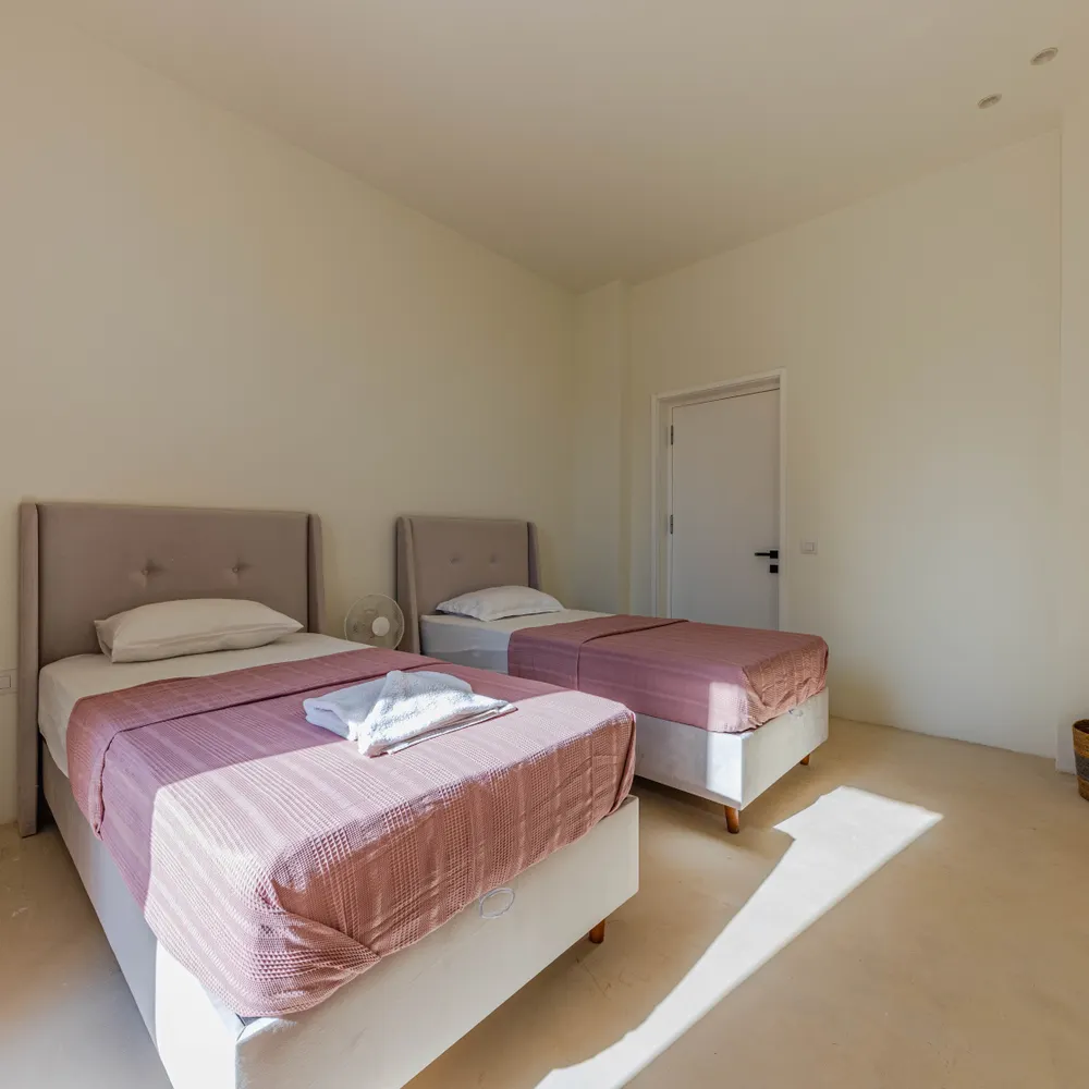A bright room with two single beds