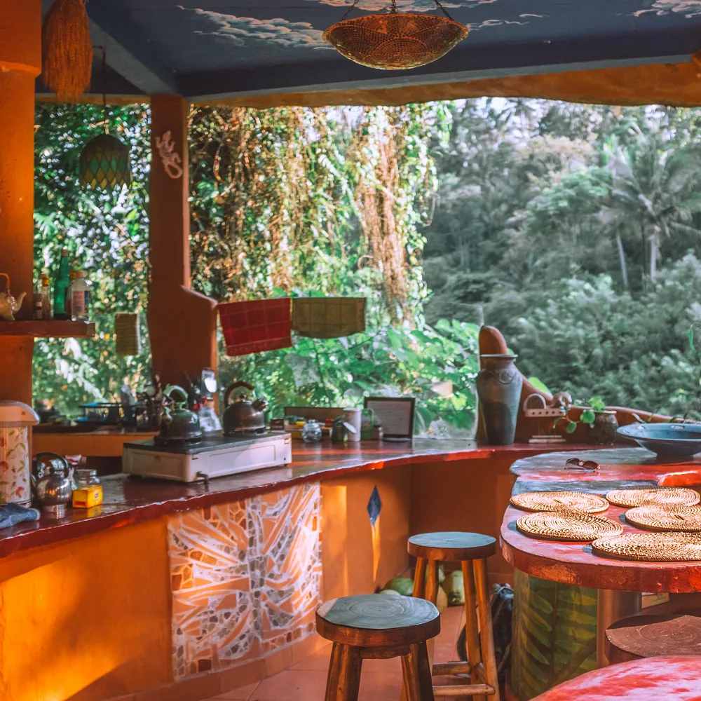 A colourful shared kitchen opening onto greenery
