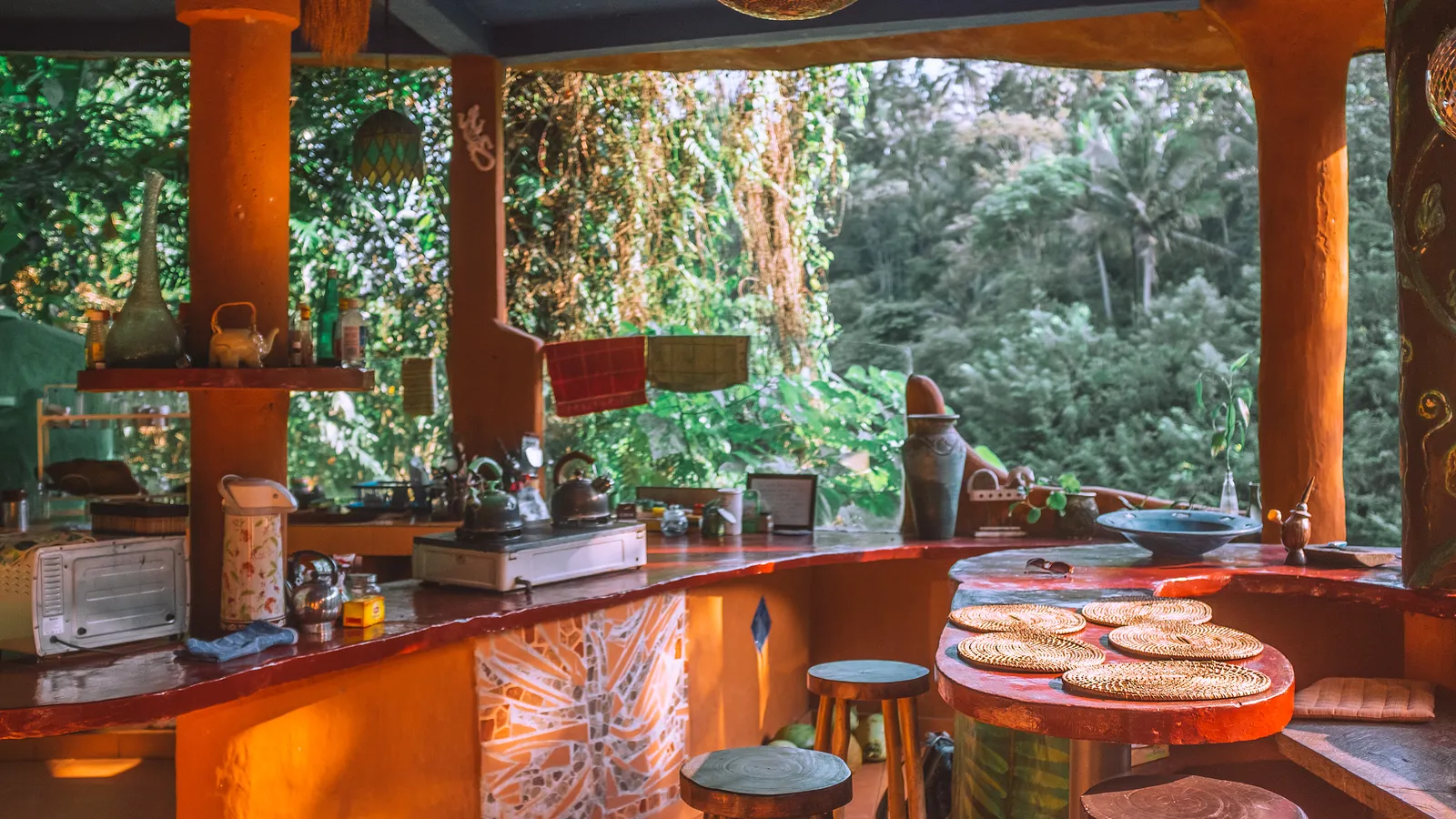 A colourful shared kitchen opening onto greenery